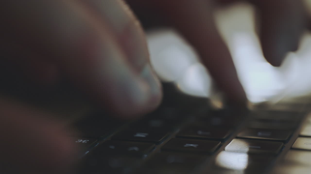 Person Typing on Laptop Keyboard
