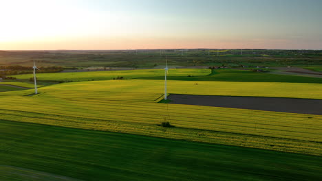 Aerial-view-focusing-on-a-single-wind-turbine-with-fields-stretching-out-in-every-direction