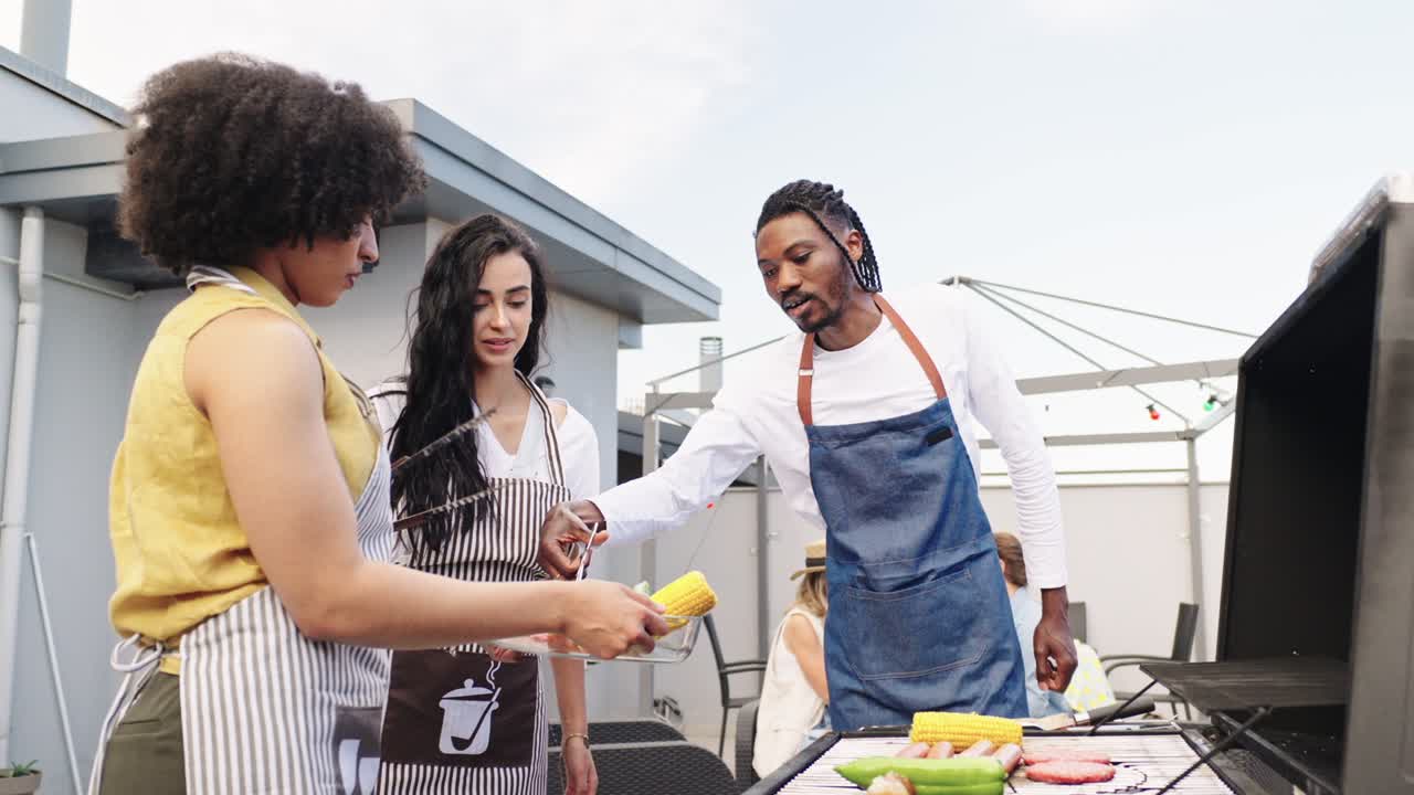Friends grilling on a roof terrace