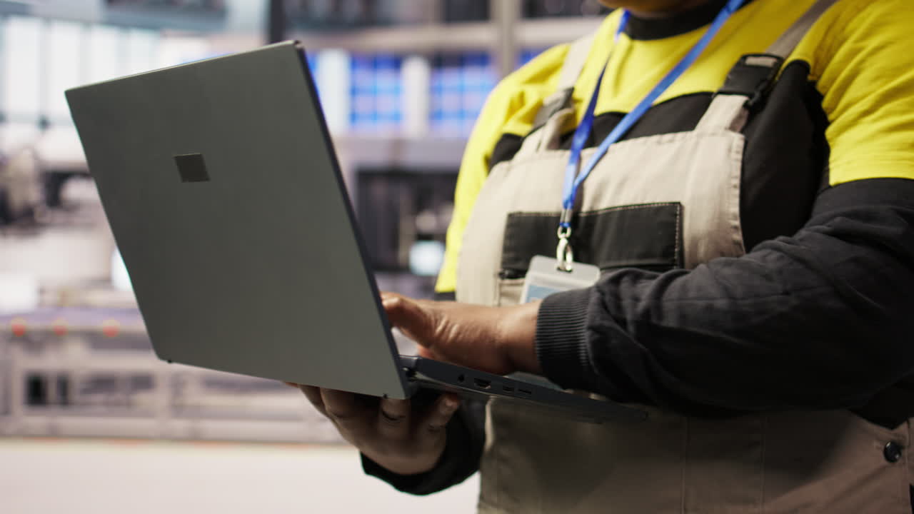 Vertical video Industrial plant expert overseeing installation process using laptop