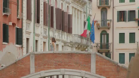 Female-tourist-walking-on-brick-bridge