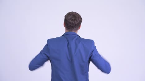 happy young handsome businessman in suit