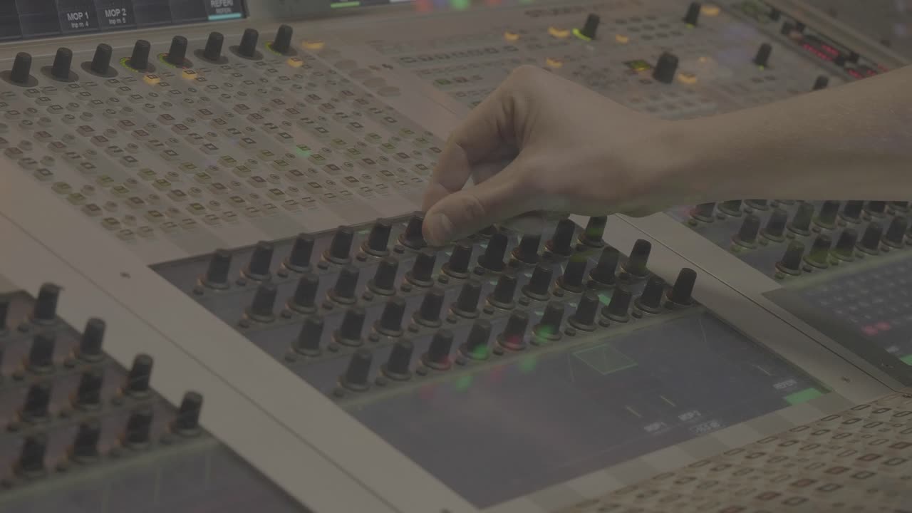Sound Engineer Adjusting Mixing Board