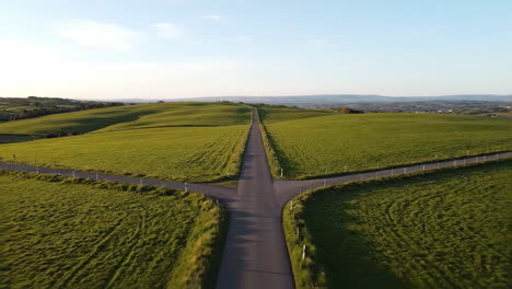 road through green fields
