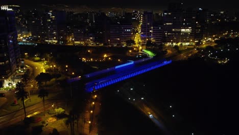 Night-time-4k-footage-of-a-bridge-being-lit-with-LED-color-changing-lights