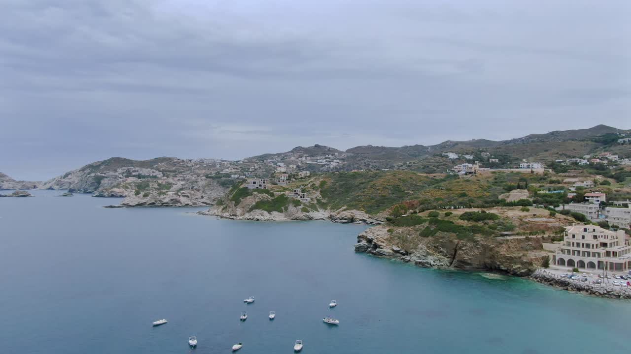 Aerial jib down of boats on the coast of Agia Pelagia, a town in the island of Crete