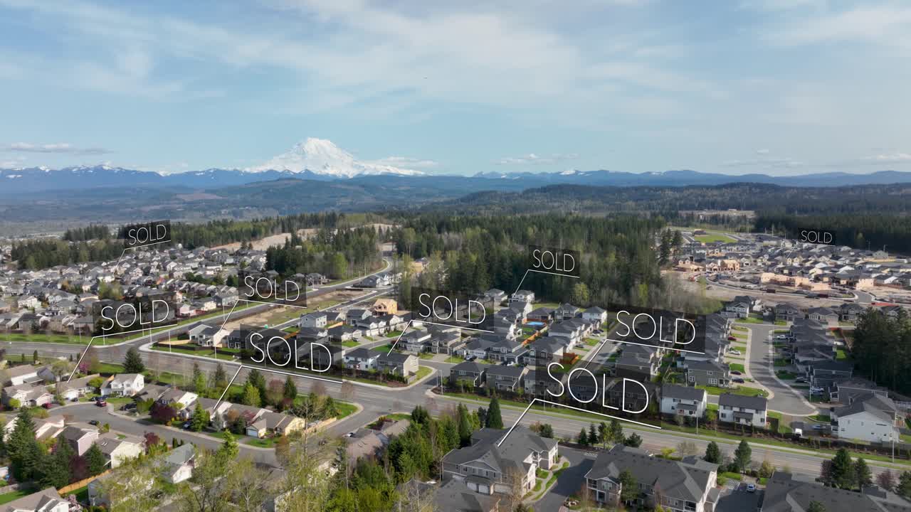 &amp;quot;SOLD&amp;quot; animations floating above suburban houses with a mountain in the distance