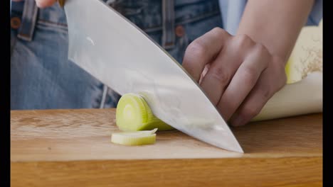 woman chopping a leek