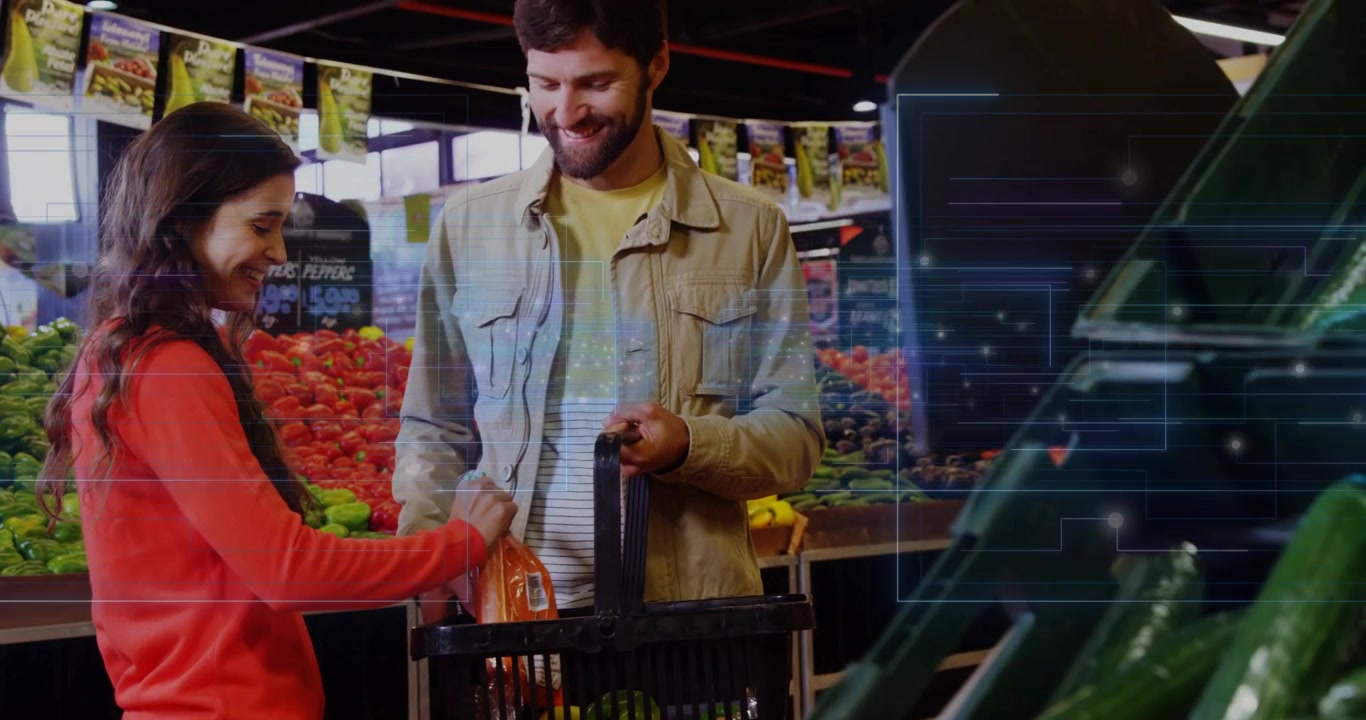 Kadın market fiyatını kontrol ediyor, havuçları sepete koyarken adam tutuyor, sağdaki katman sebzeyi gizliyor