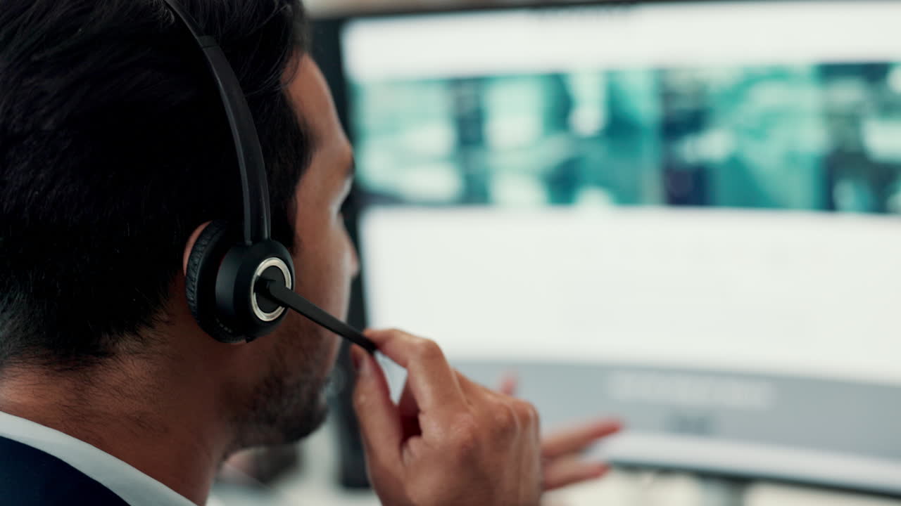 Man in Headset Talking and Gesturing During Video Call