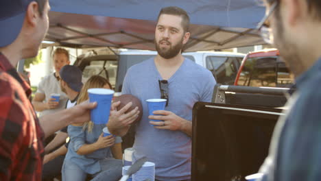 Slow-Motion-Shot-Of-Sports-Fans-Tailgating-In-Parking-Lot