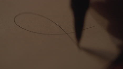 close-up of someone writing on paper