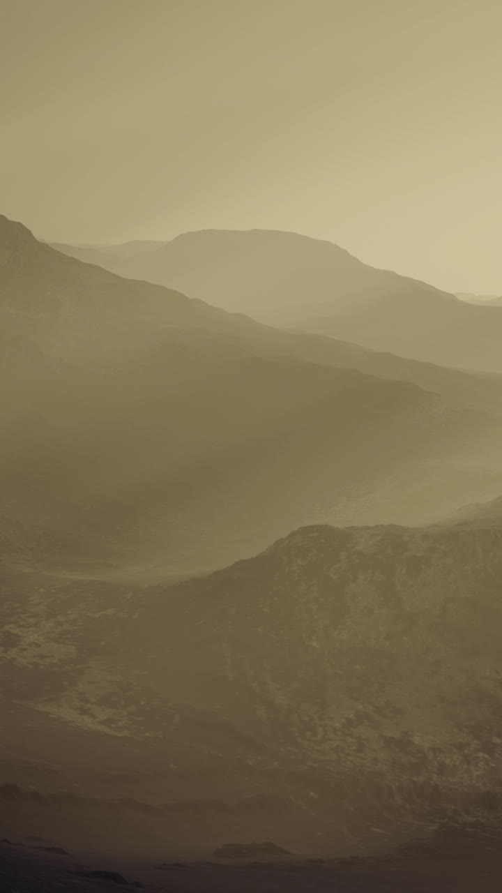 Serene mountain landscape enveloped in mist at dawn during early morning hours
