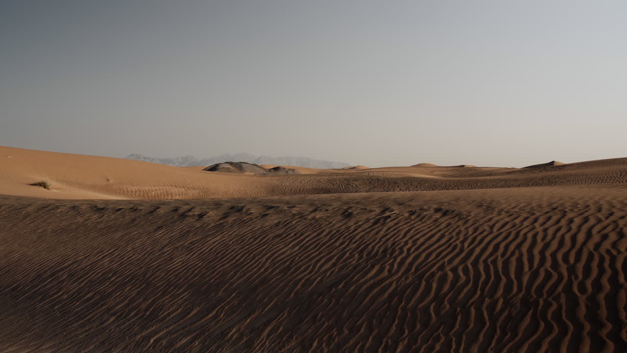 Paesaggio desertico mediorientale vicino a Dubai negli Emirati Arabi Uniti con montagne in lontananza