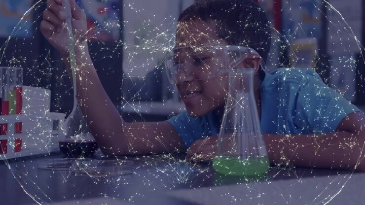 Boy reaching with pipette in school lab after network overlay fragmenting, watching reaction