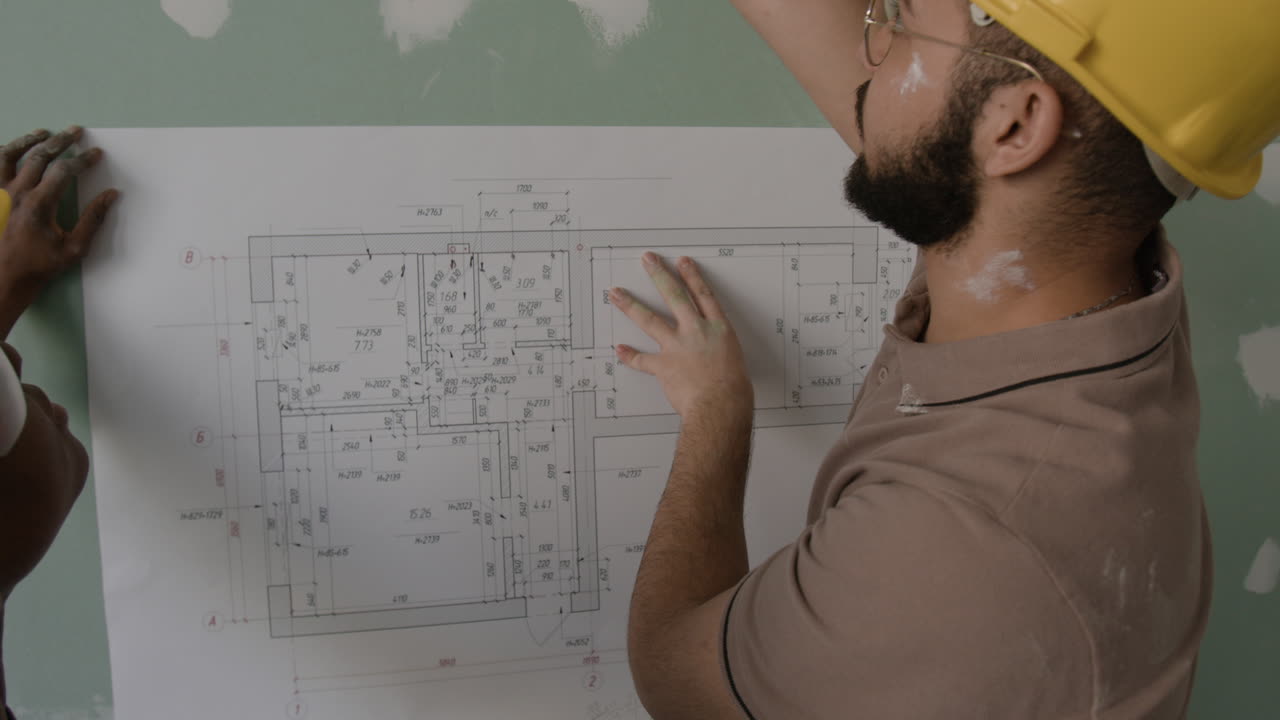 Construction workers discussing blueprints on a construction site
