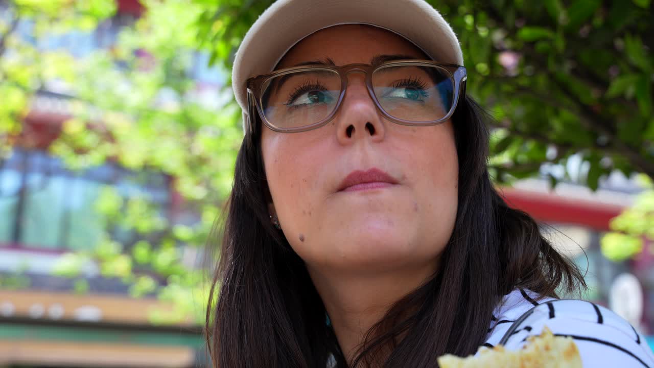Smiling European woman enjoys a Shaobing in sunny Xian street setting, China. Close up