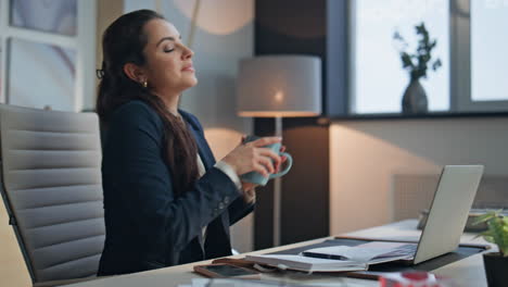 happy businesswoman holding mug with smile in office closeup. lady taking break