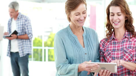 Happy-volunteer-friends-using-tablet-pc