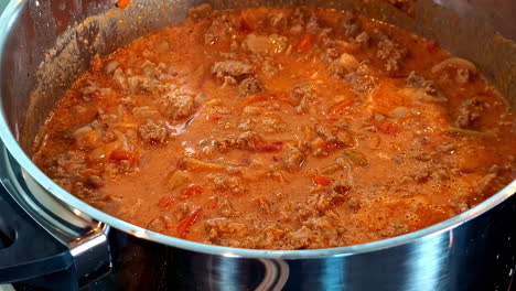 ground meat getting cooked. closeup shot.
