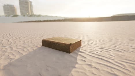 old-book-on-the-sand-beach