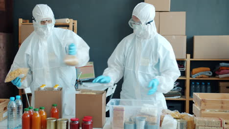 volunteers packing food donations in protective gear