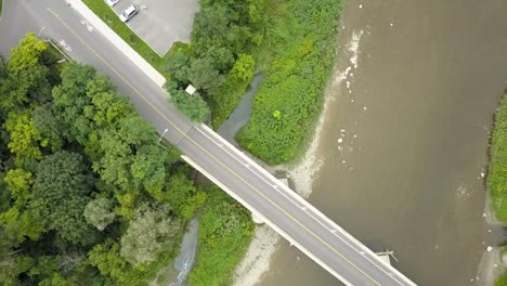 drone circling over a bridge crossing a river in toronto