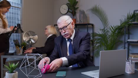 business man making fitness dumbbells exercises after hard work while sits at office desk workplace