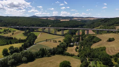 bridge infrastructure highway, in the german eifel region. motorway over crossing through a green valley. germany. aerial video