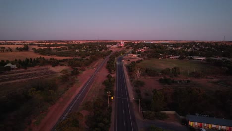 Pink-horizon-aerial-road-into-town-Sea-lake,-Victoria-Australia