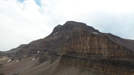 Aerial-View-of-Uinta-Mountain-Range-Steep-Sandstone-Rock-Formation-Under-Summer-Sky,-Drone-Shot