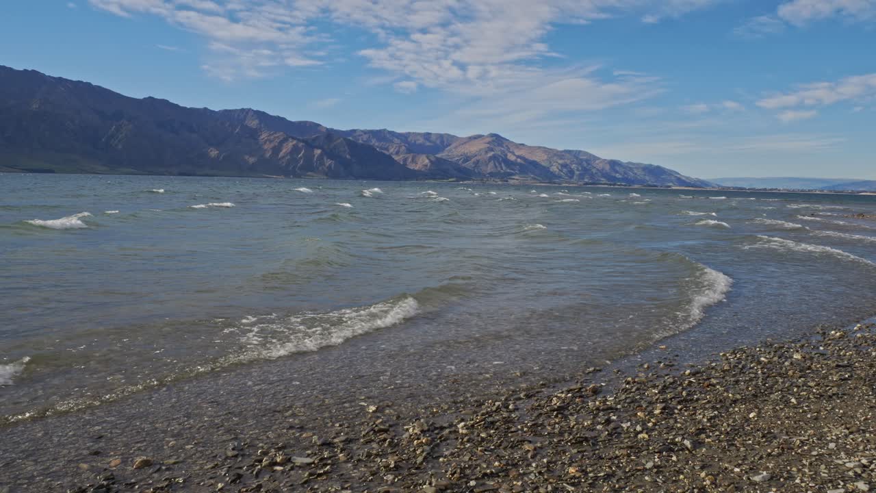 Waves On The Rocky Shore Of Lake Hawea In Otago Region, South Island, New Zealand - Wide Shot