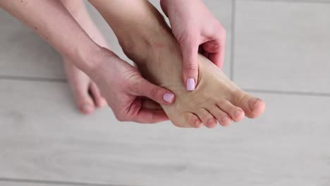 close-up of hands performing a foot massage