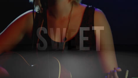 female musician playing acoustic guitar in music show, with animated sweet overlay and lighting