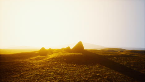 golden hour landscape with hills and grass