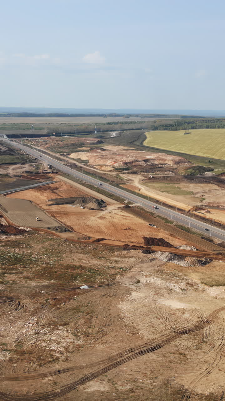 Aerial view of a new highway under construction in a rural landscape