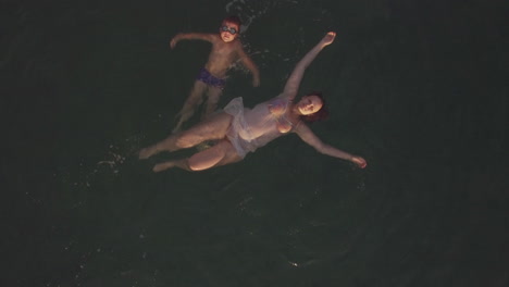 flying over mother and son swimming in the sea