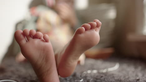 the bare feet of a 3 year old child as they relax on a sofa