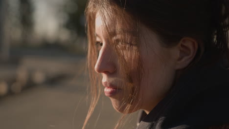 close-up of a depressed girl with her hair partially covering her face. she appears sad and lost in thought, her expression reflecting deep melancholy and introspection