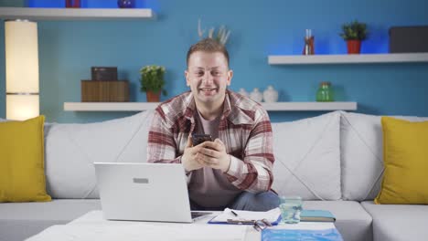 home office worker man getting good news on the phone.