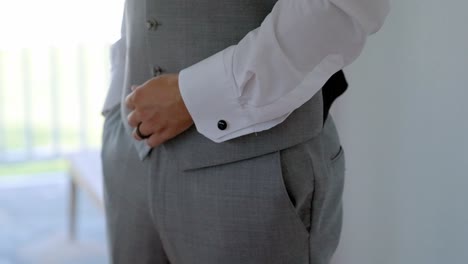 wedding groom fixing waistcoat elegant style