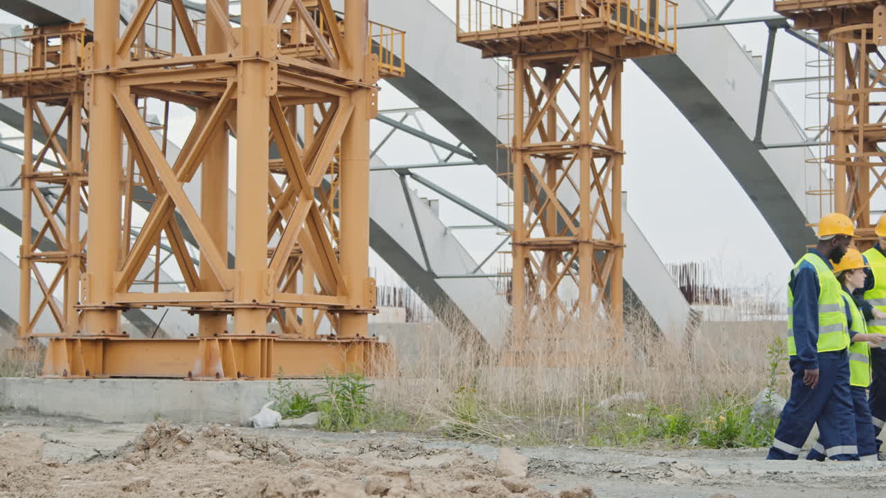 Construction Engineers Walking and Discussing Work