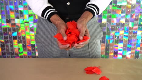 red rose petals falling through the hands, artificial flower decor