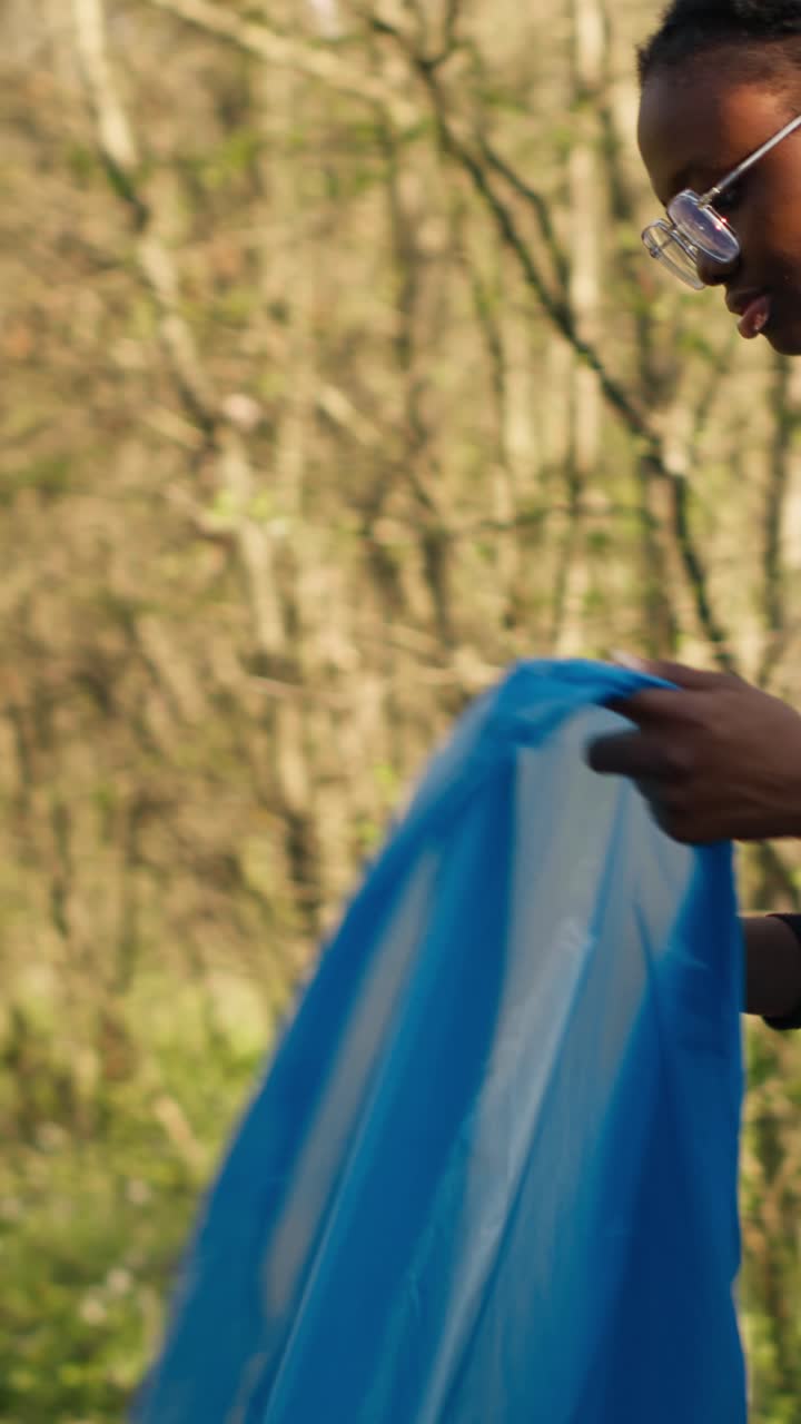 Young Woman Volunteer Cleaning Up Nature with Trash Picker