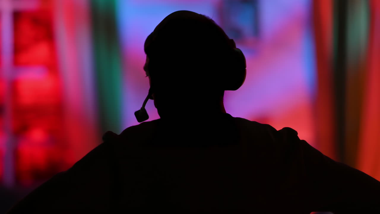 Silhouette of the director of photography with an audio headset in a television studio. Backstage of the preparation for the show