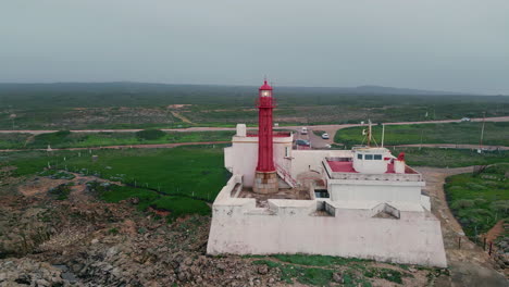 gloomy landscape ocean lighthouse drone view. cloudy sky seaside with highway