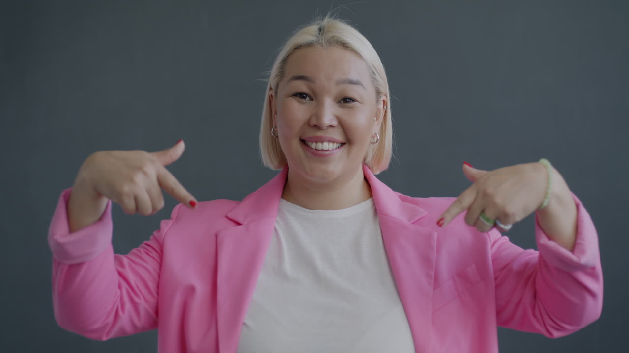 Smiling Woman Pointing at Herself