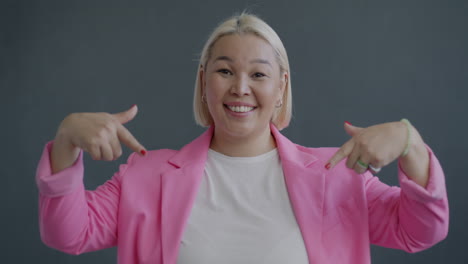 Smiling Woman Pointing at Herself