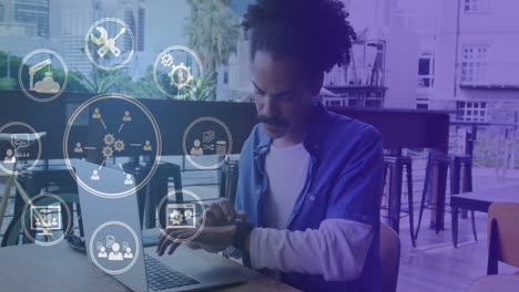 Animation of network of connections with icons over man using laptop