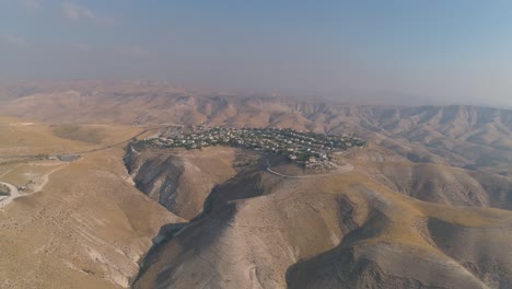 jewish settlement at the desert of judea and samaria in israel . aerial view drone shot of village houses on top hill mountains view. outdoor mediterranean coexist living